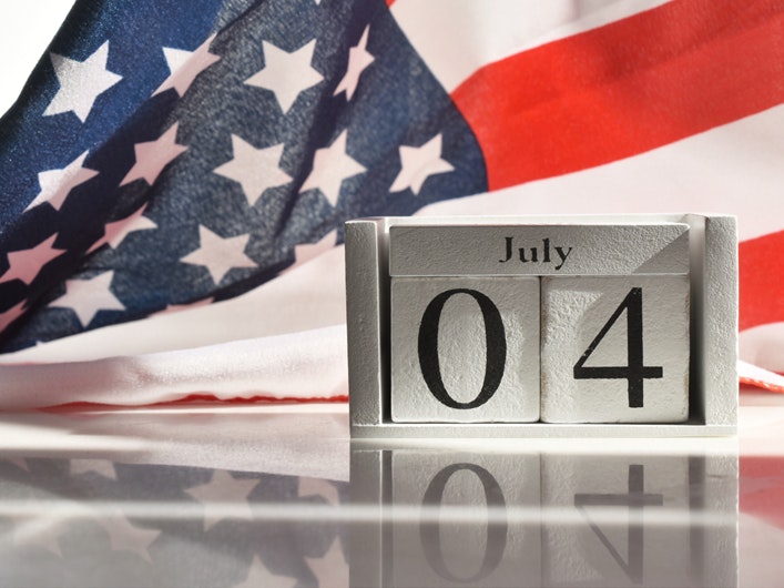 American flag and calendar displaying July Fourth.