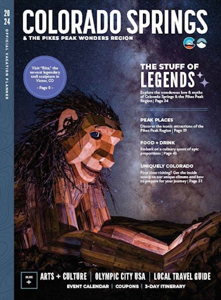 Cover of a magazine showing a large wooden troll against a starry night sky
